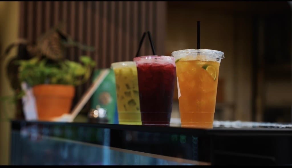 Three iced house drinks on the bar