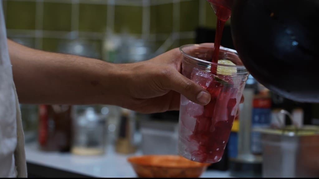 Iced drink poured over ice and lime